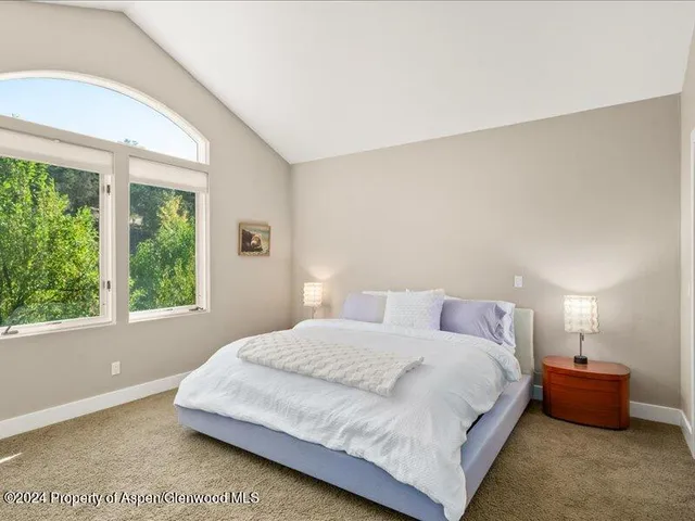 a bedroom with a bed and window