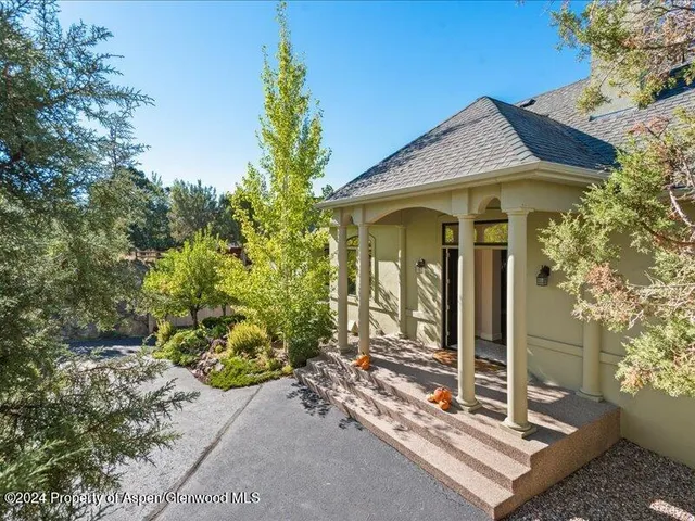 a view of a house with potted plants