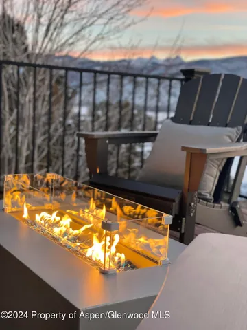 a terrace with outdoor seating and trees