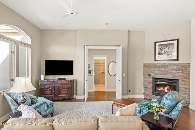 a living room with furniture a fireplace and a flat screen tv