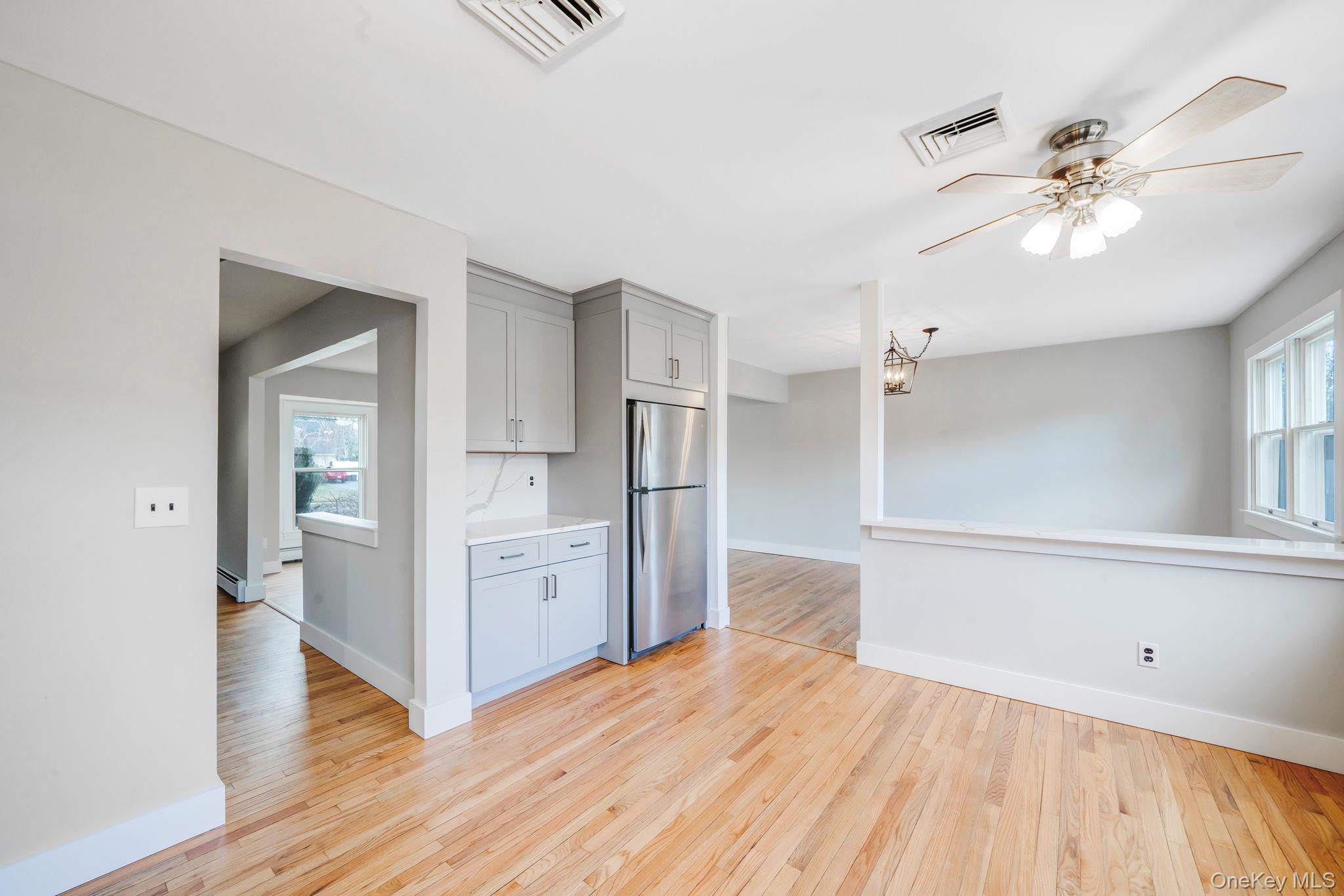 71 Loop Drive Sayville, NY 11782 - Photo 13 of 45 a view of a kitchen with wooden floor cabinets and a kitchen