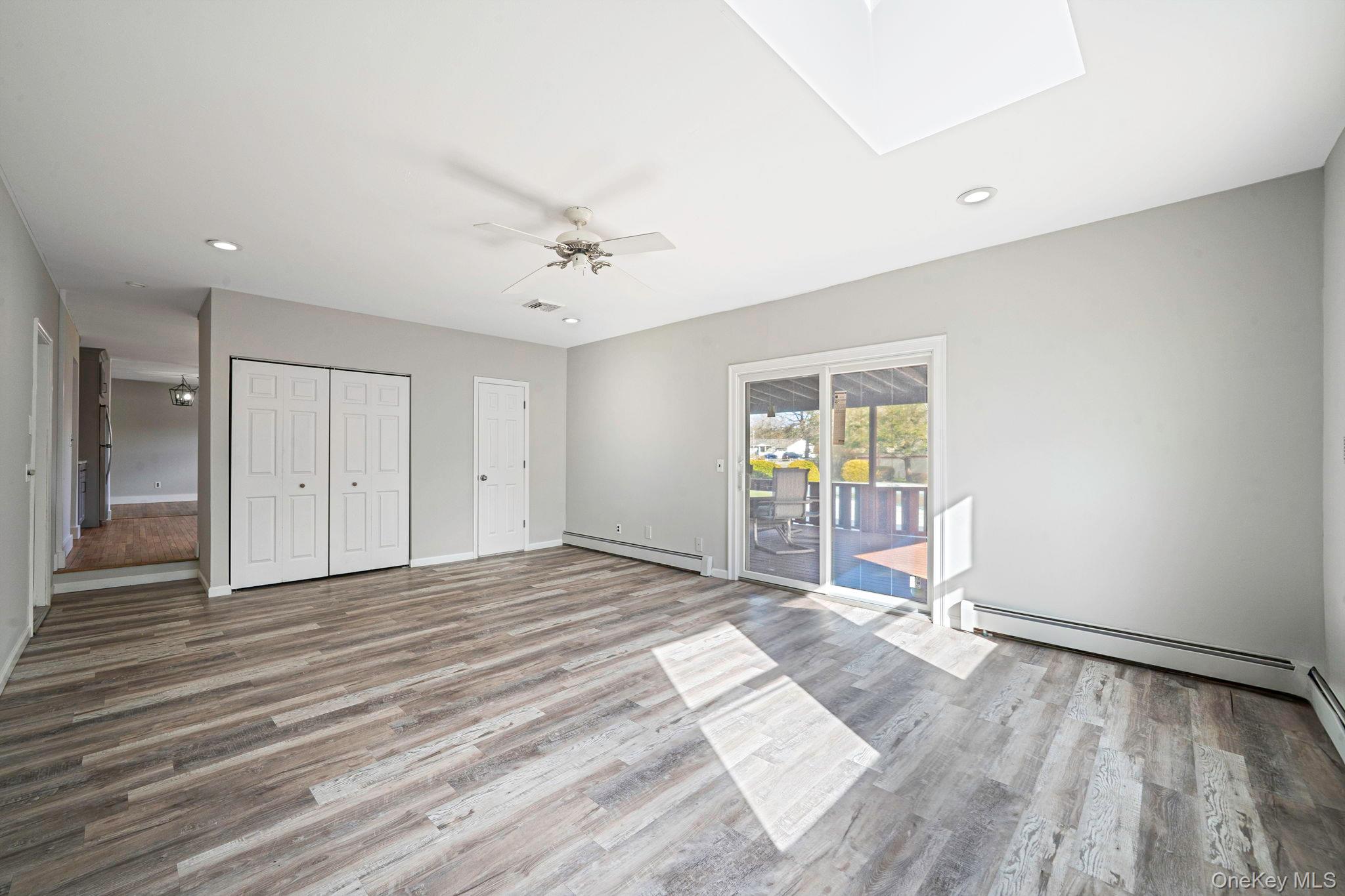 71 Loop Drive Sayville, NY 11782 - Photo 14 of 45 a view of an empty room with wooden floor and a window