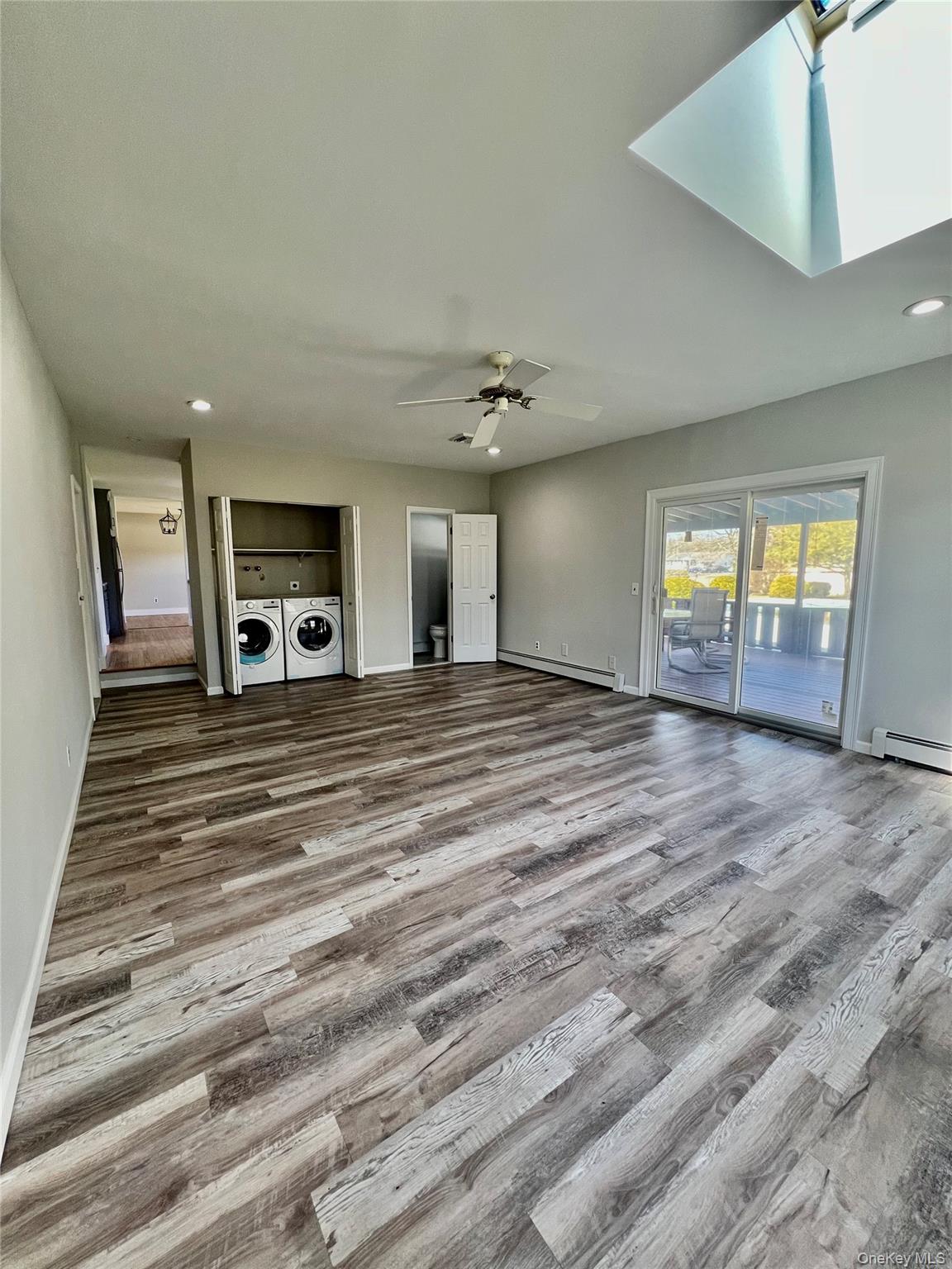 71 Loop Drive Sayville, NY 11782 - Photo 17 of 45 a view of a livingroom with wooden floor and a fireplace