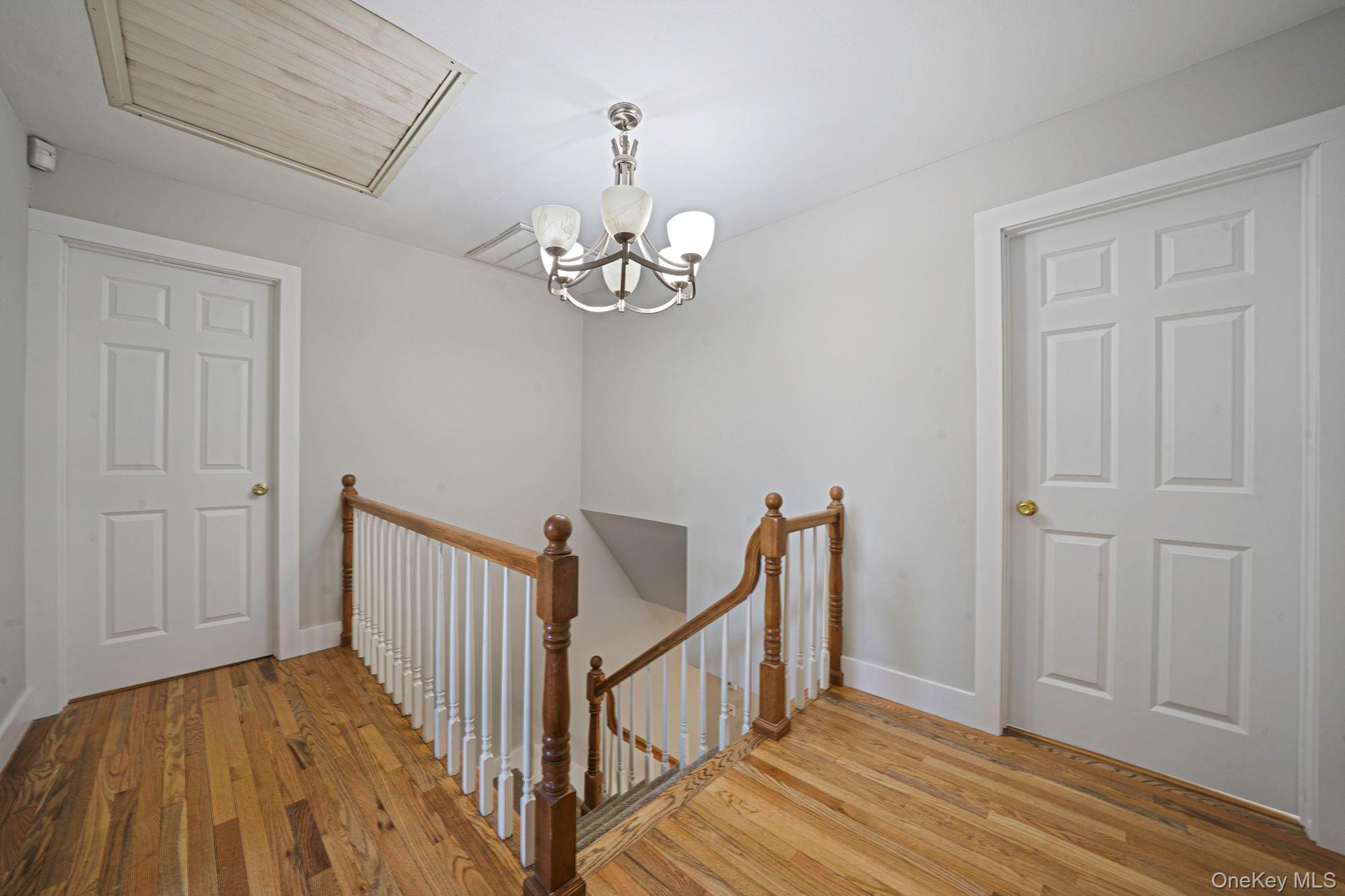 71 Loop Drive Sayville, NY 11782 - Photo 20 of 45 a view of a hallway with wooden floor and staircase