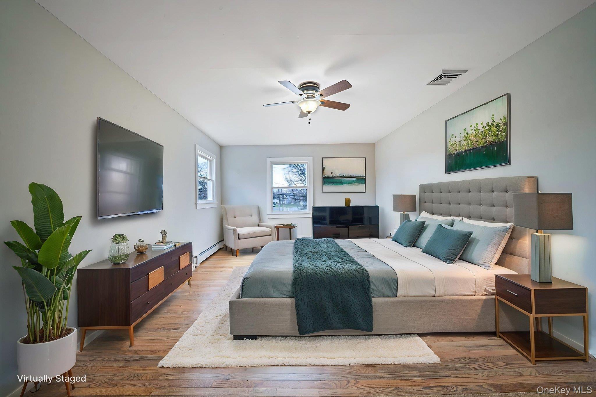 71 Loop Drive Sayville, NY 11782 - Photo 22 of 45 a bedroom with a large bed and a flat screen tv