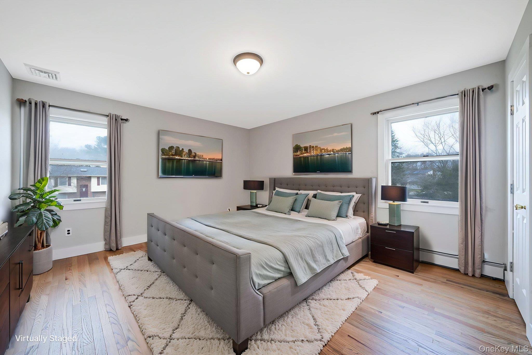 71 Loop Drive Sayville, NY 11782 - Photo 27 of 45 a bedroom with a large bed and a flat tv screen