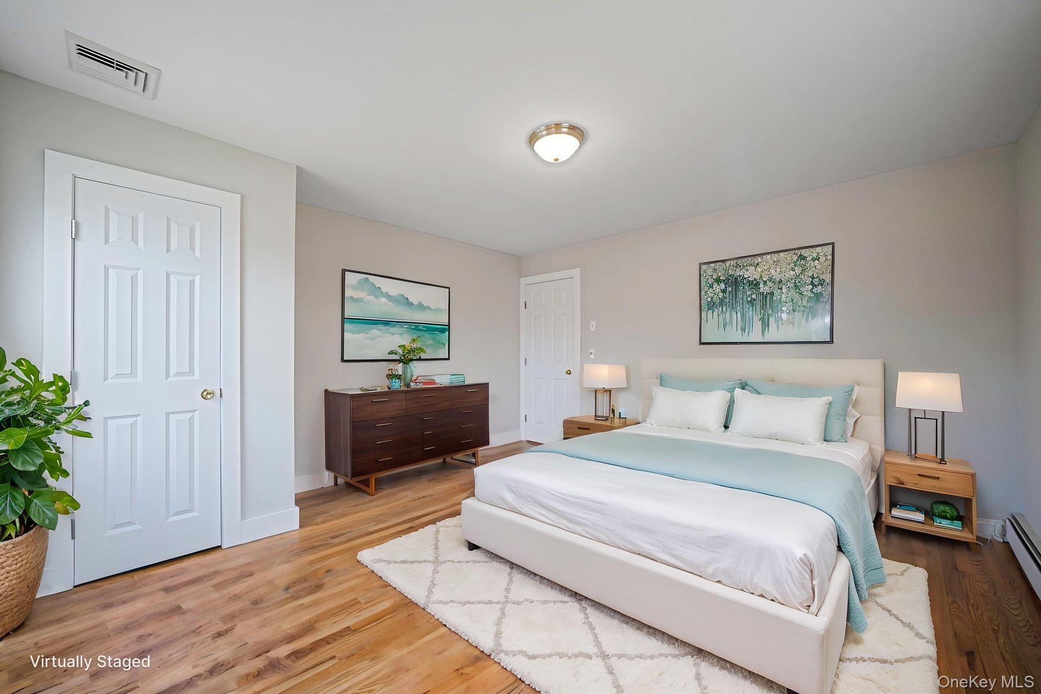 71 Loop Drive Sayville, NY 11782 - Photo 30 of 45 a spacious bedroom with a bed and a couch