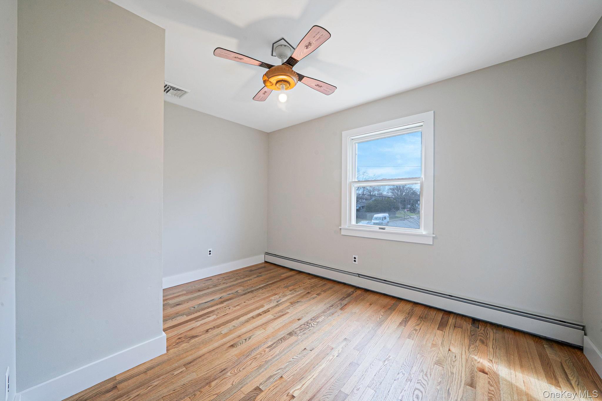 71 Loop Drive Sayville, NY 11782 - Photo 31 of 45 a view of an empty room with wooden floor and a window