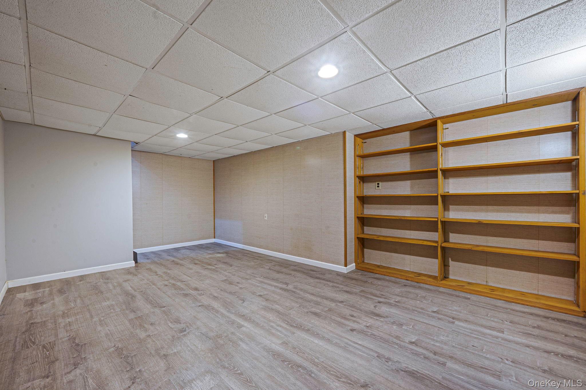 71 Loop Drive Sayville, NY 11782 - Photo 33 of 45 a view of an empty room with wooden floor and a window
