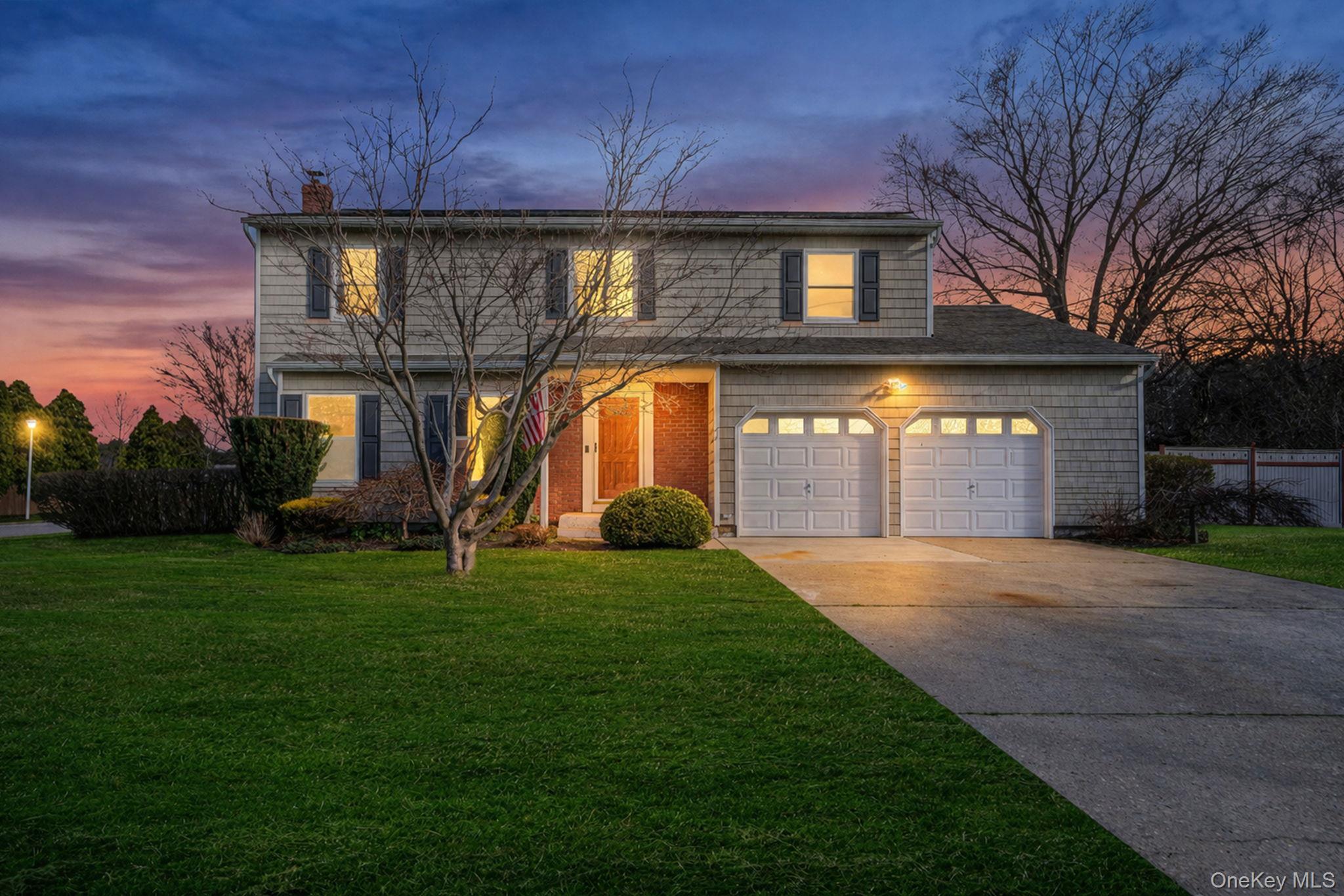 71 Loop Drive Sayville, NY 11782 - Photo 4 of 45 a front view of a house with a yard and garage