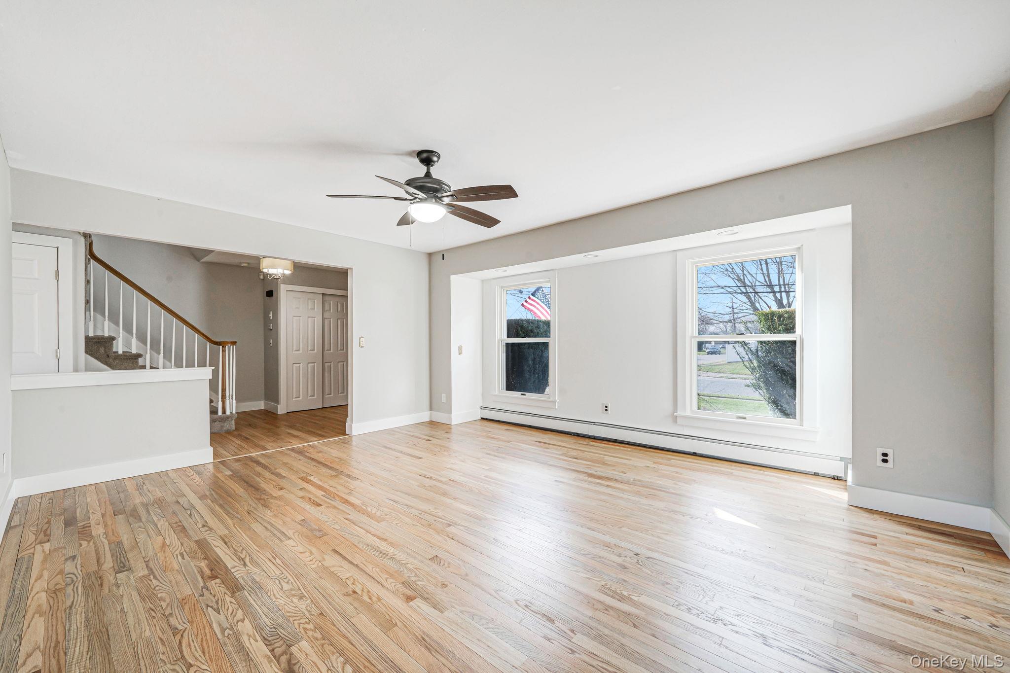 71 Loop Drive Sayville, NY 11782 - Photo 5 of 45 a view of an empty room with wooden floor and a window