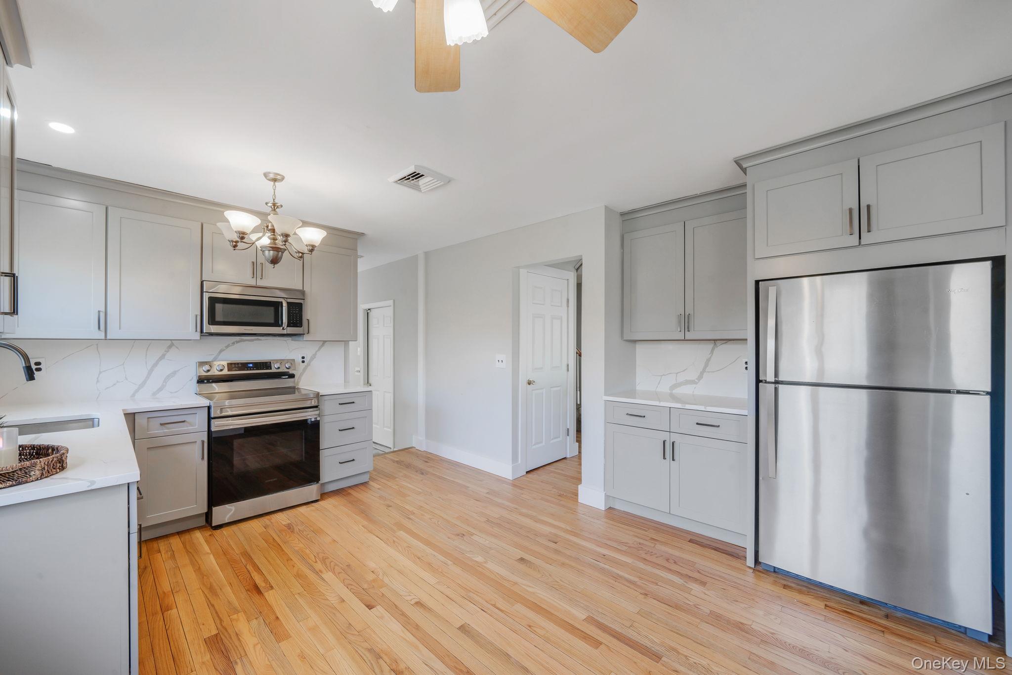 71 Loop Drive Sayville, NY 11782 - Photo 10 of 45 a kitchen with granite countertop a refrigerator stove top oven and sink
