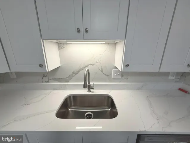 a kitchen with a sink and cabinets