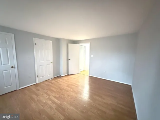 a view of an empty room and wooden floor