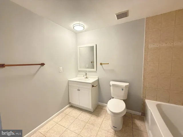 a bathroom with a toilet sink and shower