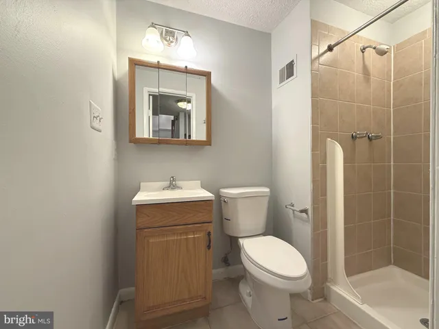 a bathroom with a toilet sink and shower