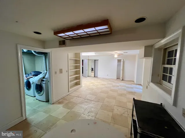 a view of a hallway with wooden shelves