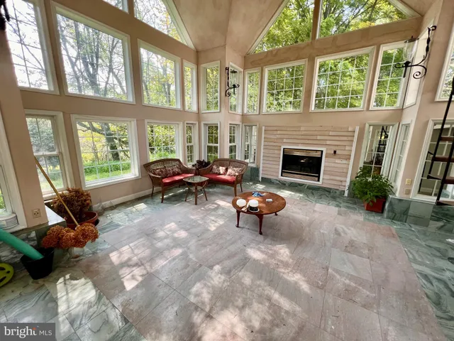 a view of a livingroom with furniture hardwood floor and a ceiling fan