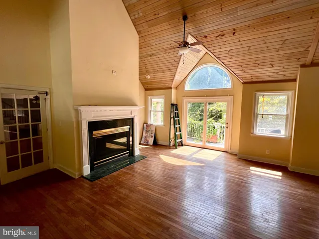 an empty room with chandelier fan