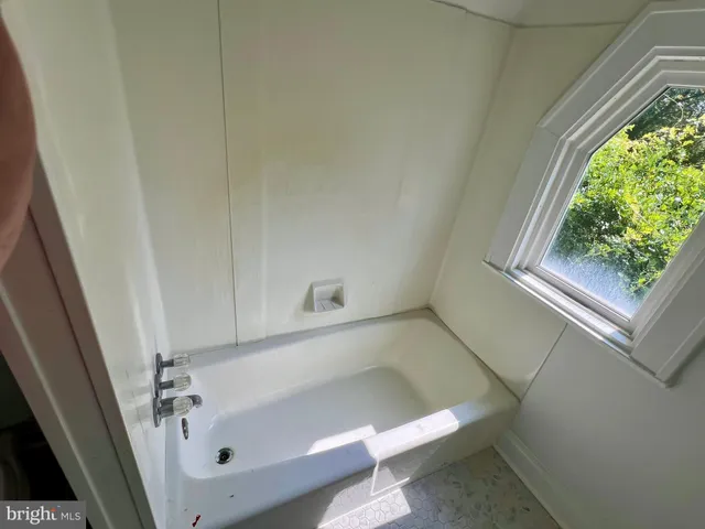 a white toilet sitting next to a shower