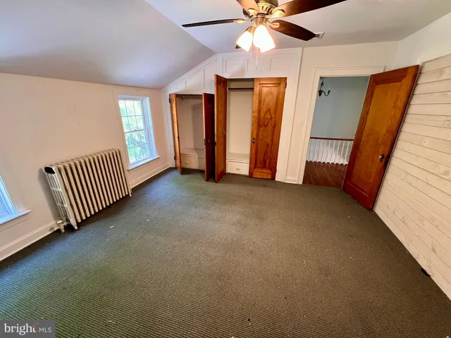 a view of a livingroom with a ceiling fan and window