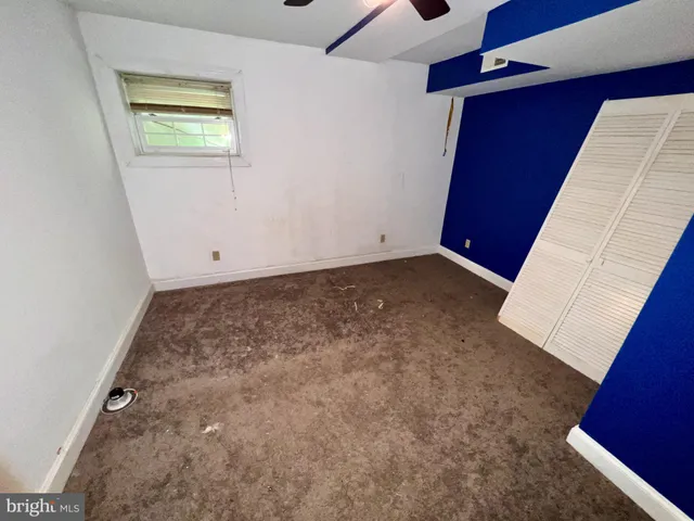 a view of a livingroom with wooden floor and a ceiling fan