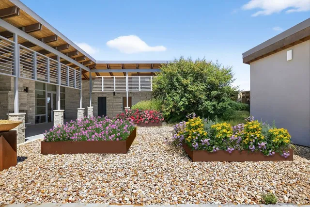 a view of a porch with potted plants
