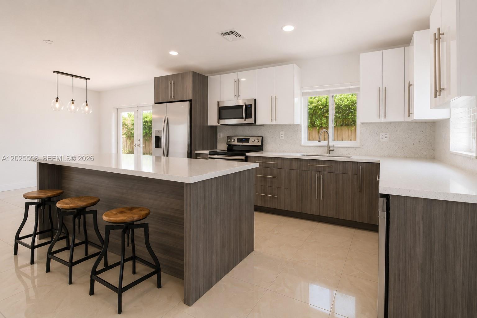 9421 Southwest 150th Street Miami, FL 33176 - Photo 9 of 31 a kitchen with stainless steel appliances a sink stove and refrigerator