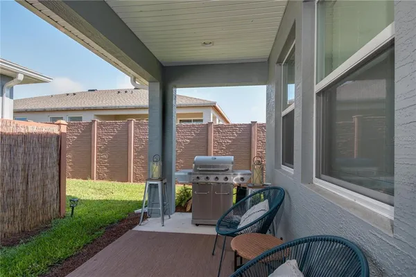 a view of a porch with furniture and a yard