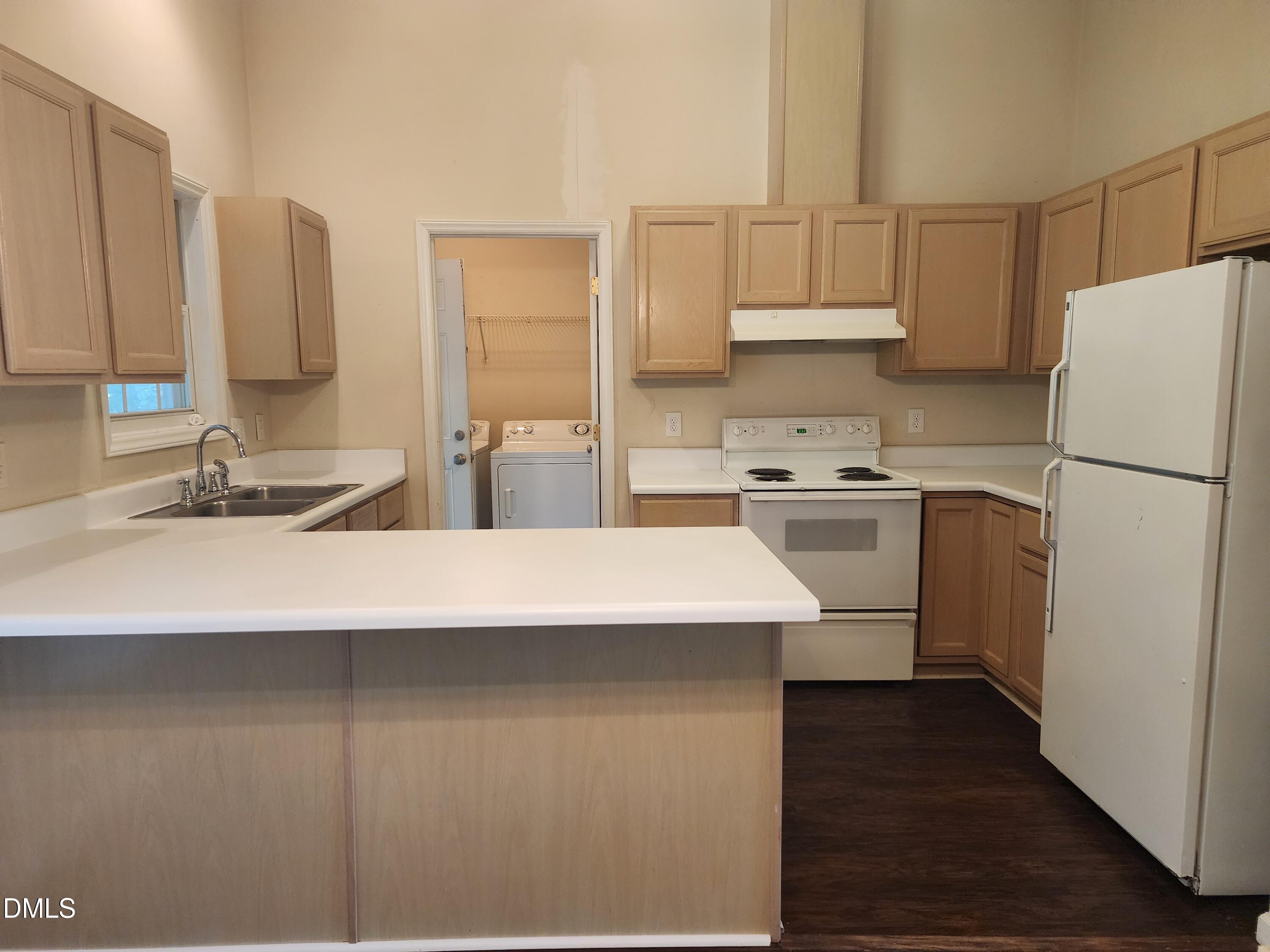518 Johnson Street Garner, NC 27529 - Photo 8 of 17 a kitchen with a sink a refrigerator and cabinets