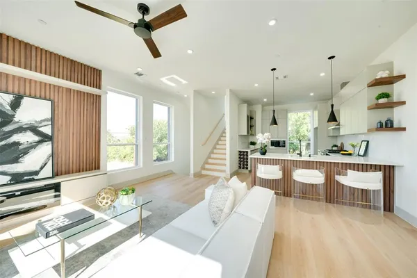 a kitchen with sink and view of living room
