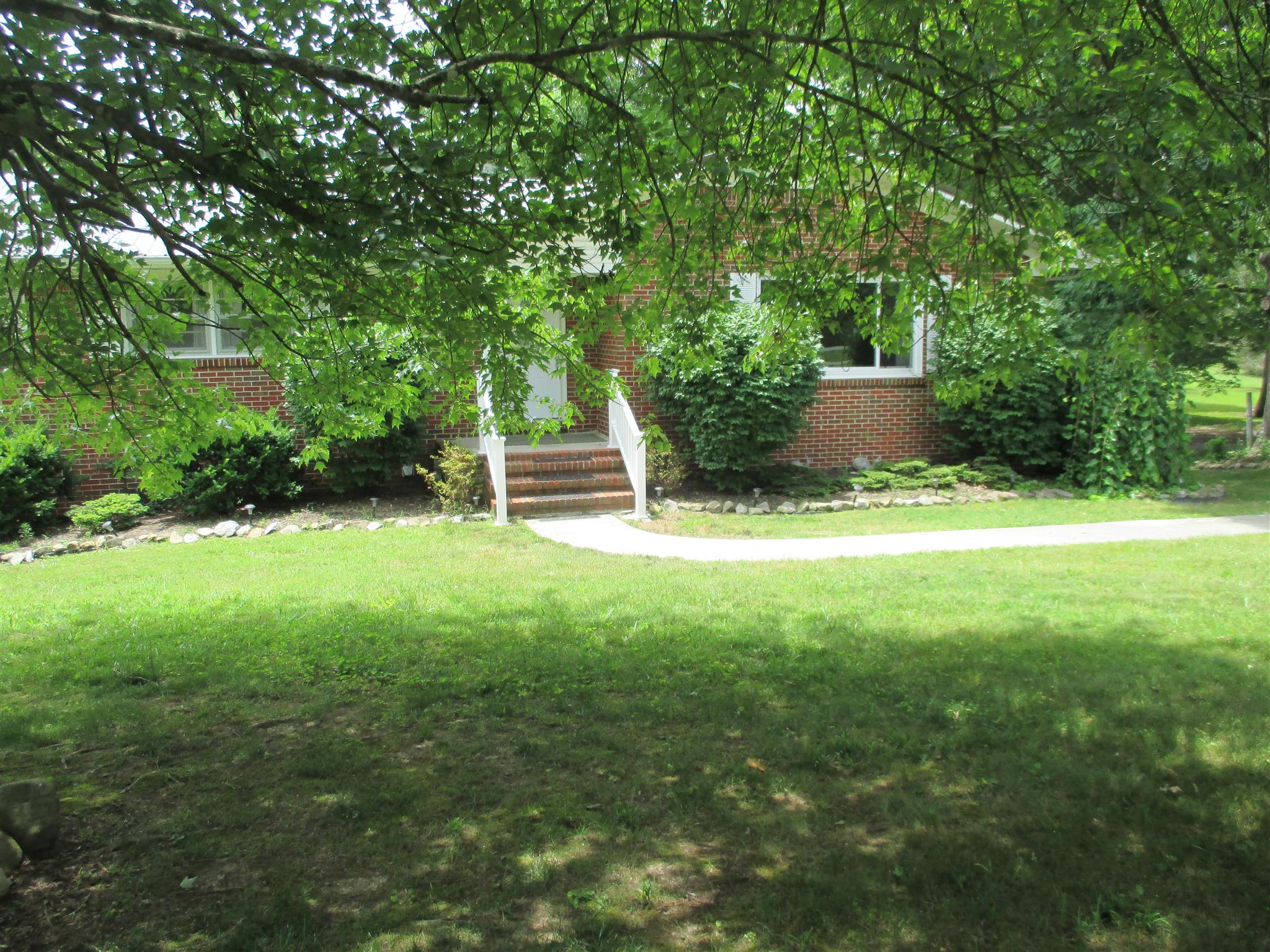 304 Shelton Road Manchester, TN 37355 - Photo 2 of 21 a backyard of a house with table and chairs a barbeque