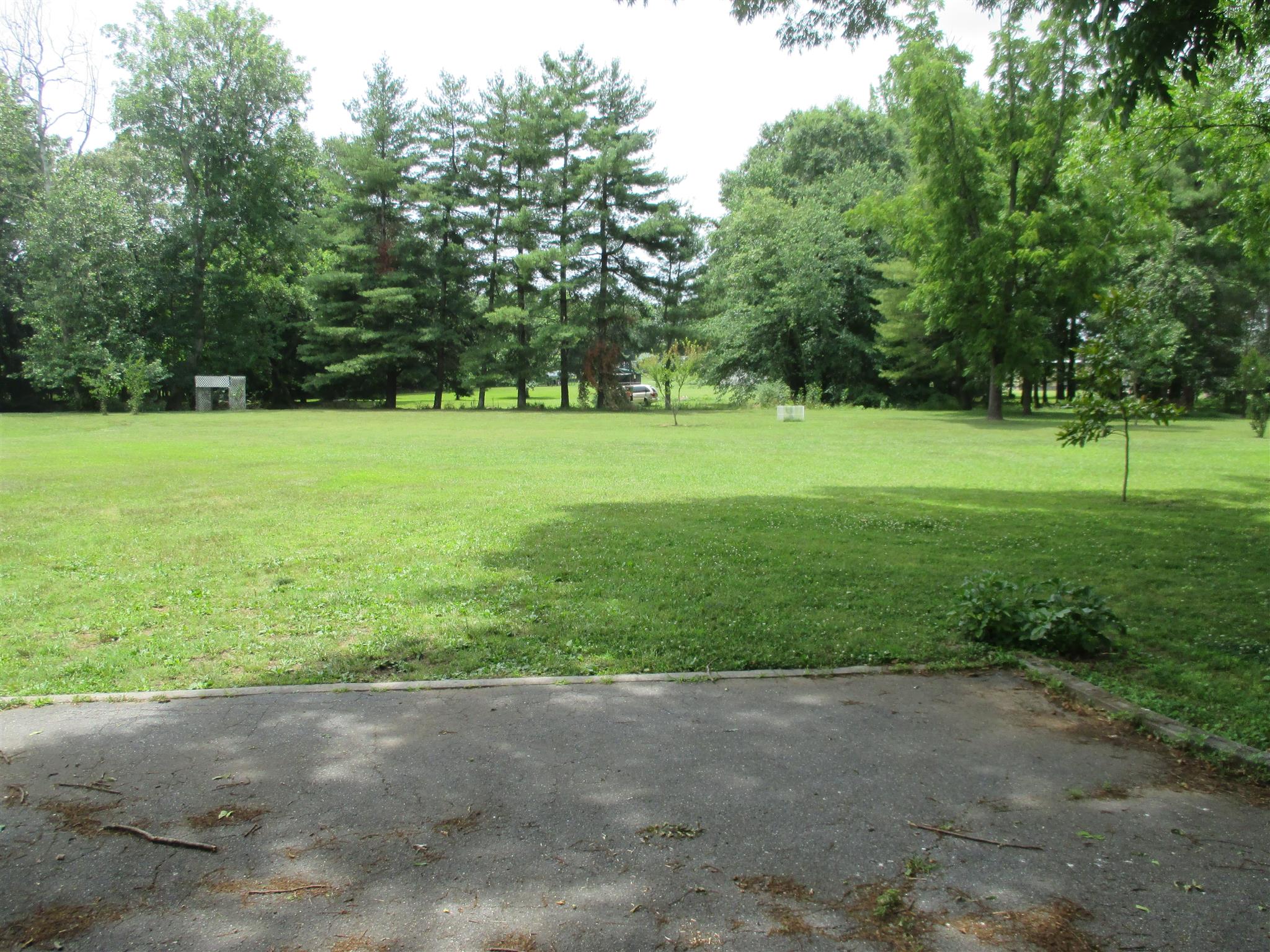 304 Shelton Road Manchester, TN 37355 - Photo 8 of 21 a view of a field with trees in the background