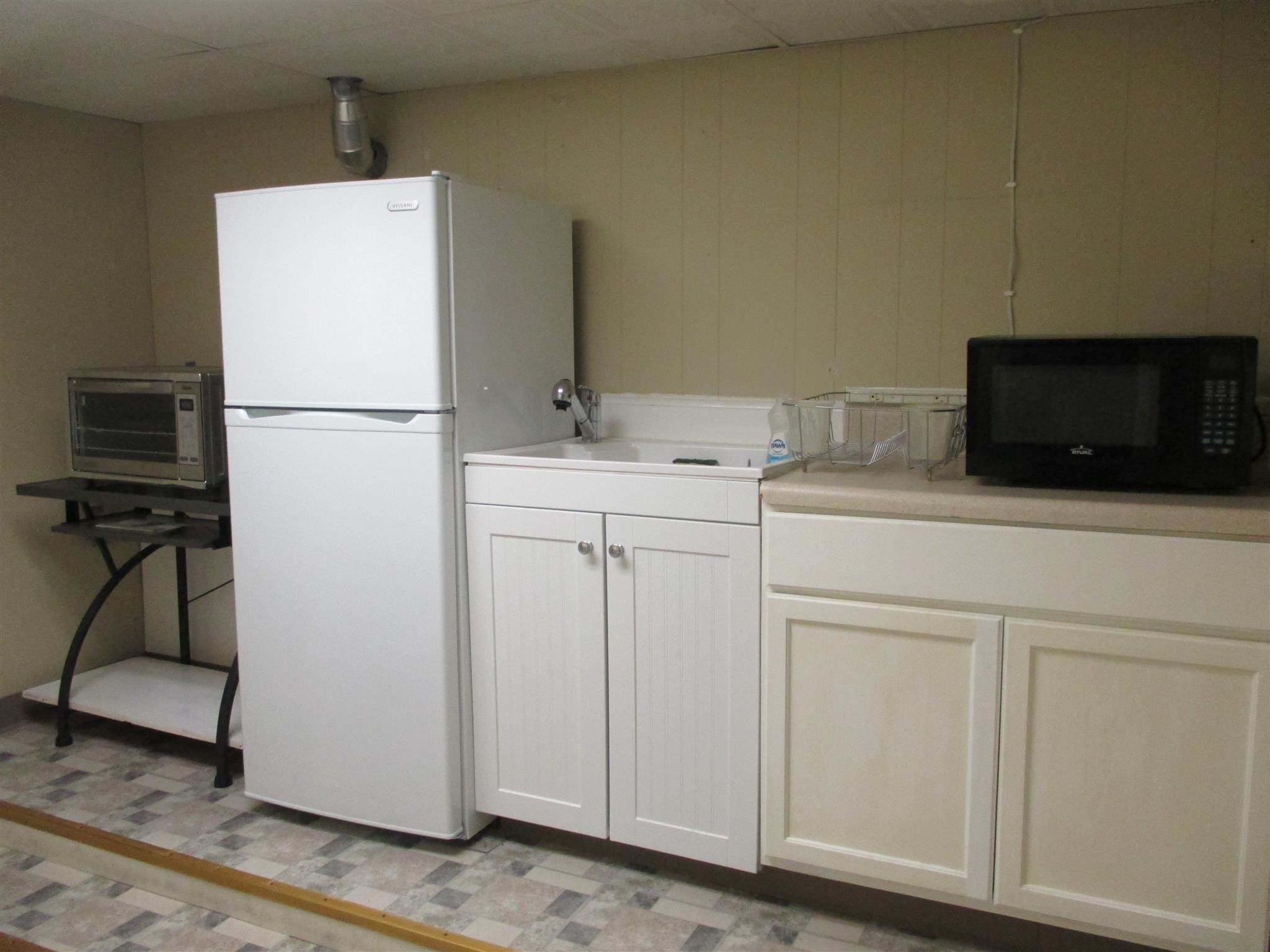 304 Shelton Road Manchester, TN 37355 - Photo 10 of 21 a kitchen with a sink a refrigerator and cabinets