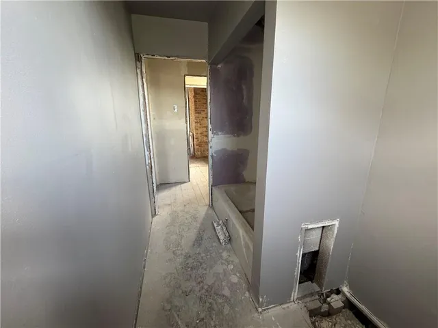 a view of a hallway with storage and utility