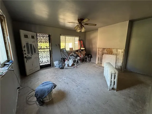 a living room with furniture gym equipment and a window