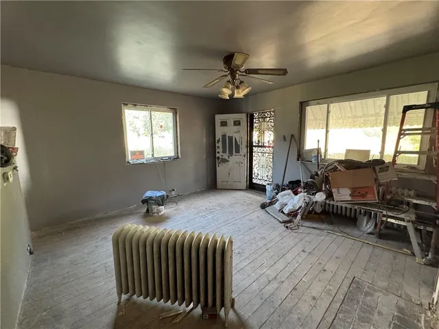 a bedroom with furniture and a large window