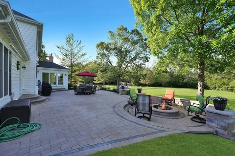 a wooden bench sitting in the middle of a yard