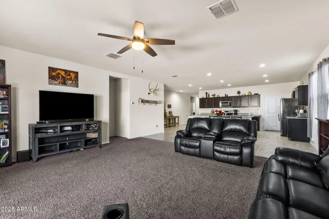 a view of a livingroom with furniture and a kitchen