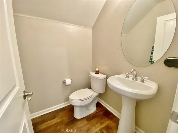 a bathroom with a sink toilet and a mirror