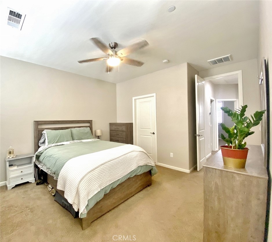 44011 Rivo Court Temecula, CA 92592 - Photo 23 of 39 a bedroom with a bed and a potted plant