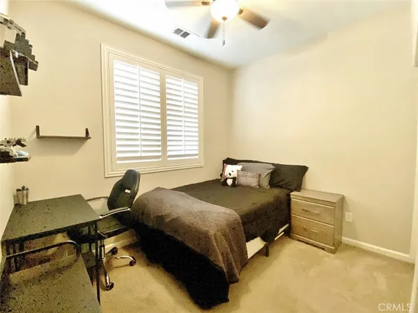 a bedroom with a bed and a desk
