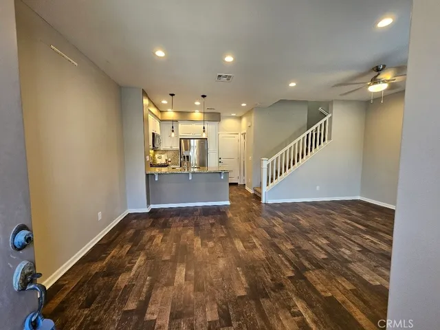 a view of kitchen and hall with wooden floor