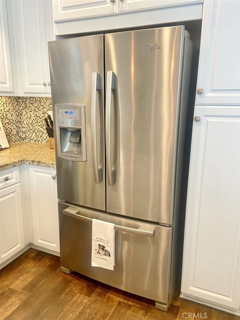 44011 Rivo Court Temecula, CA 92592 - Photo 7 of 39 a view of a refrigerator with wooden floor
