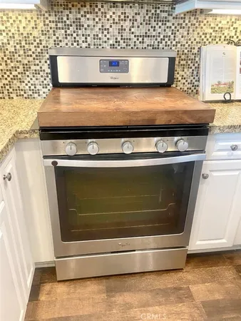 a close view of stove with granite counter top