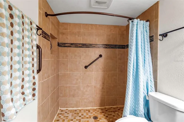 a bathroom with a shower and a toilet