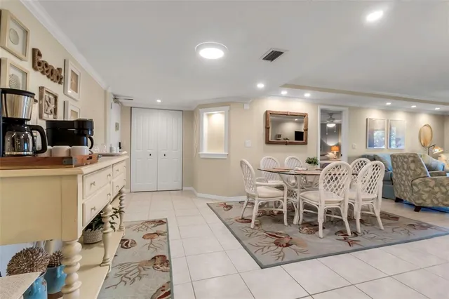 a living room with furniture a flat screen tv and kitchen view