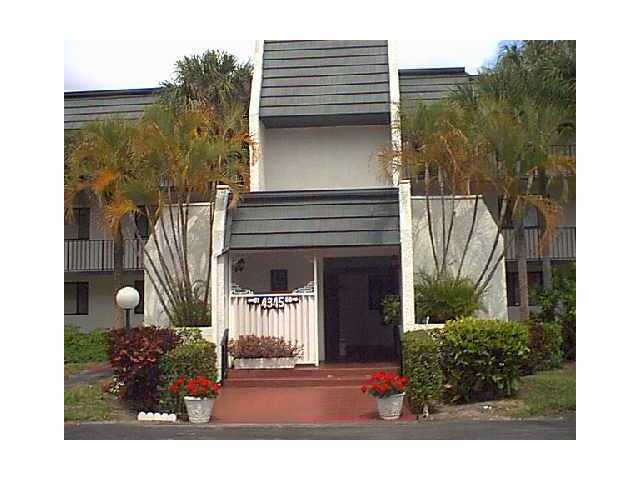 4345 Trevi Court, Unit 208 Lake Worth, FL 33467 - Photo 1 of 20 a front view of a house with garden