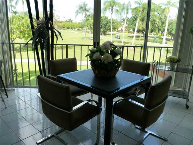 4345 Trevi Court, Unit 208 Lake Worth, FL 33467 - Photo 11 of 20 a view of a dining room with furniture window and outside view