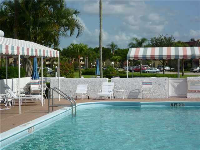 4345 Trevi Court, Unit 208 Lake Worth, FL 33467 - Photo 13 of 20 a view of a bench sitting in a yard